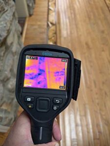 Person removing carpet in basement